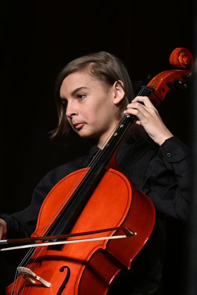Student plays cello at OMA showcase