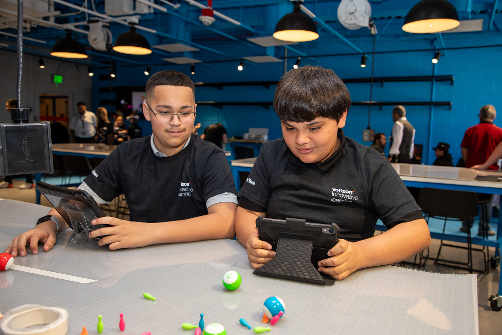 Two students play with tablets in the learning lab