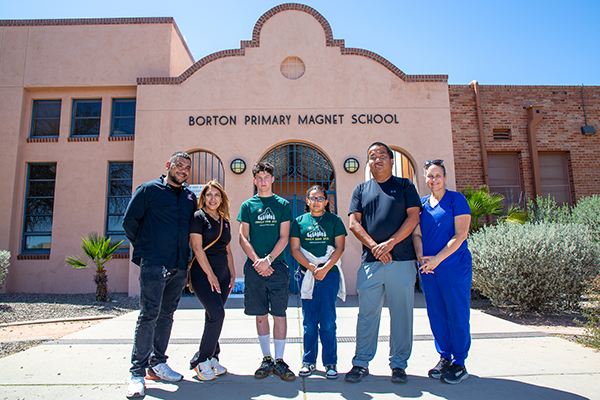 A boy and girl, center, stand with their school nurses and the two community members who helped make their camp trip possible