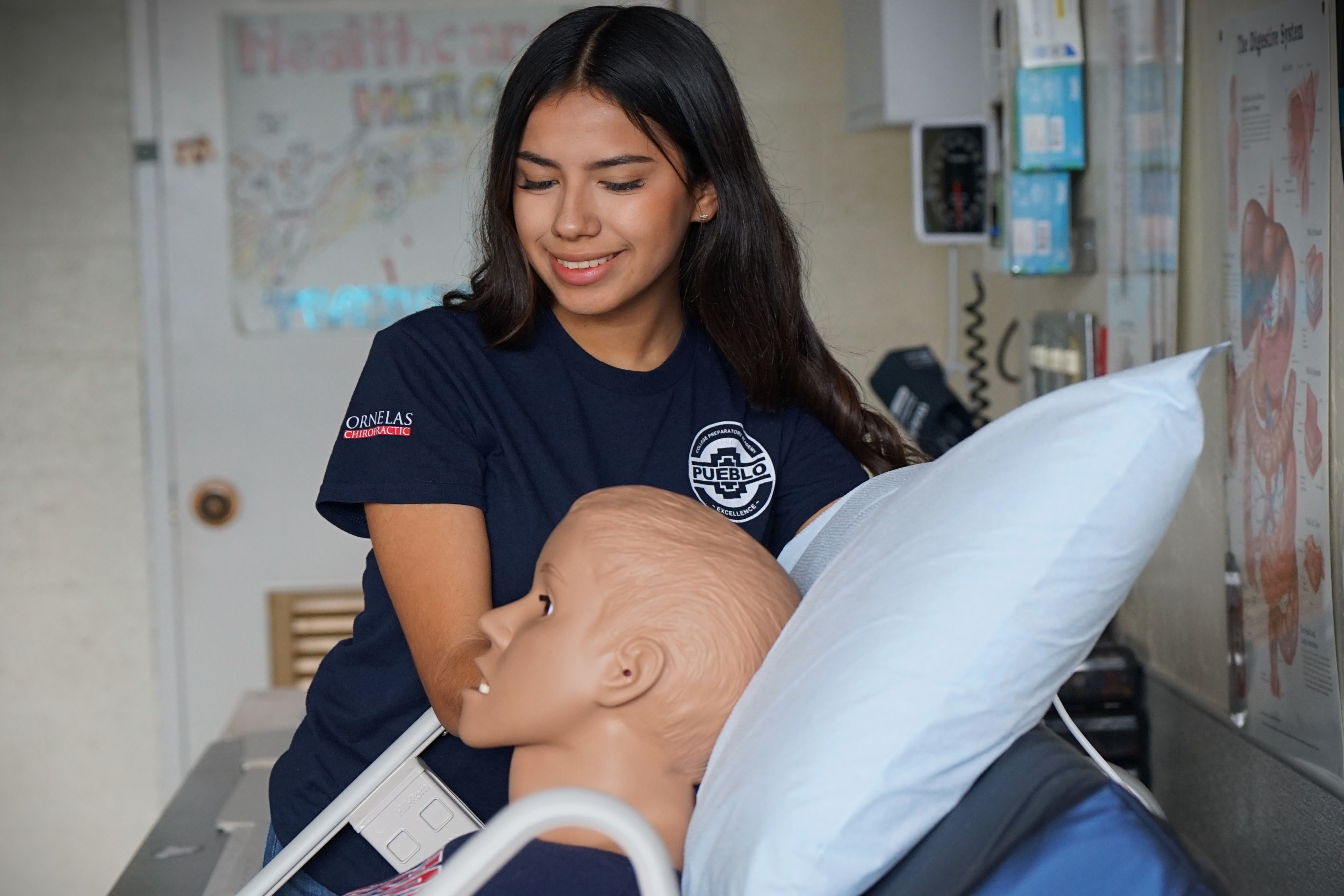 Pueblo High School senior Ailyn Gamez poses with the medical dummy she uses in her healthcare classes