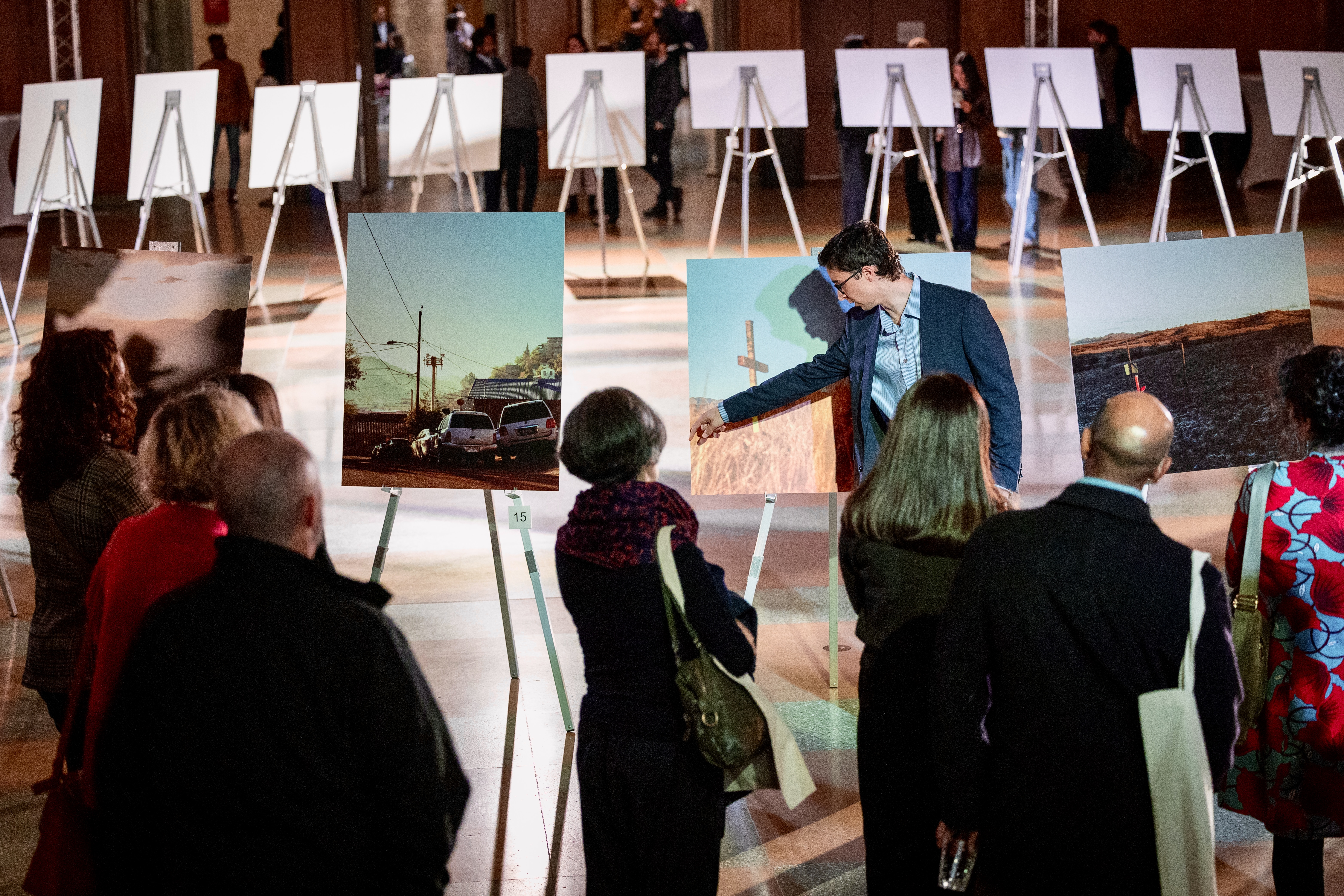 A young man shows his photography in a gallery