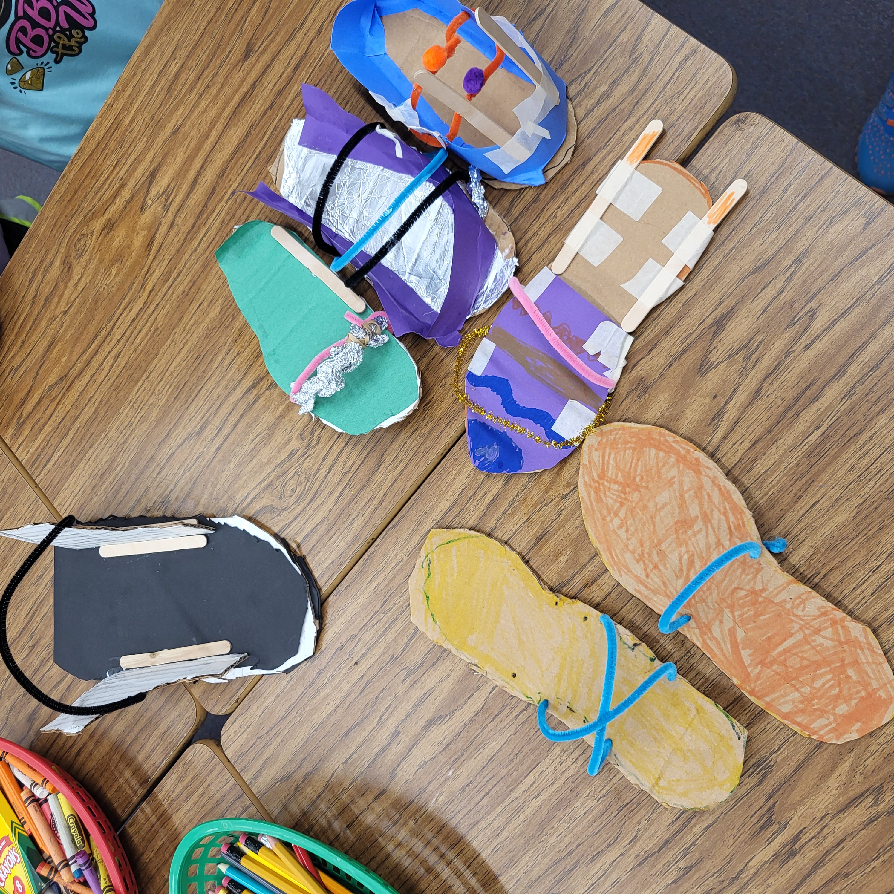 Picture of student made shoes made from crafting material as part of our Survivor unit.