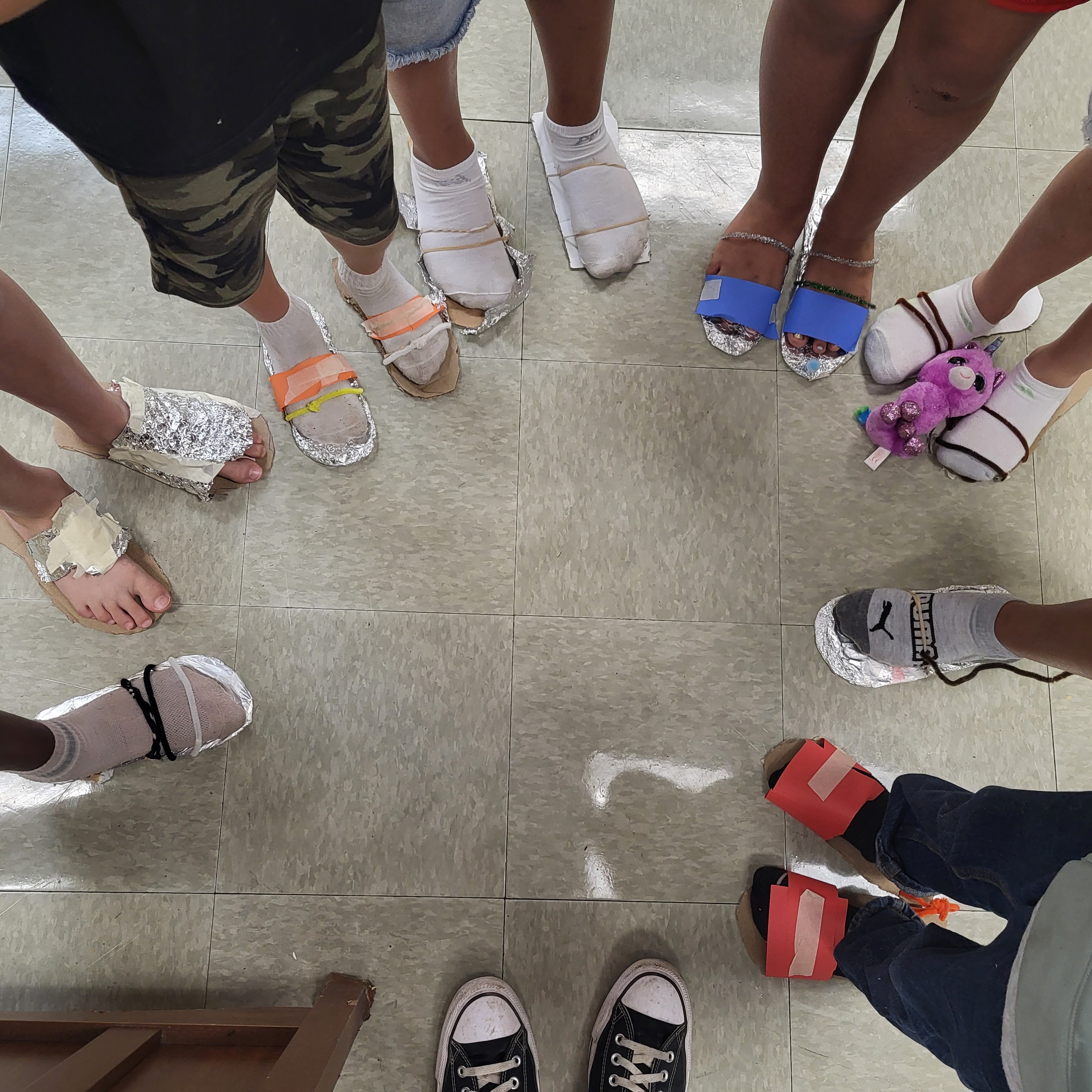 Picture of student made shoes made from crafting material as part of our Survivor unit.