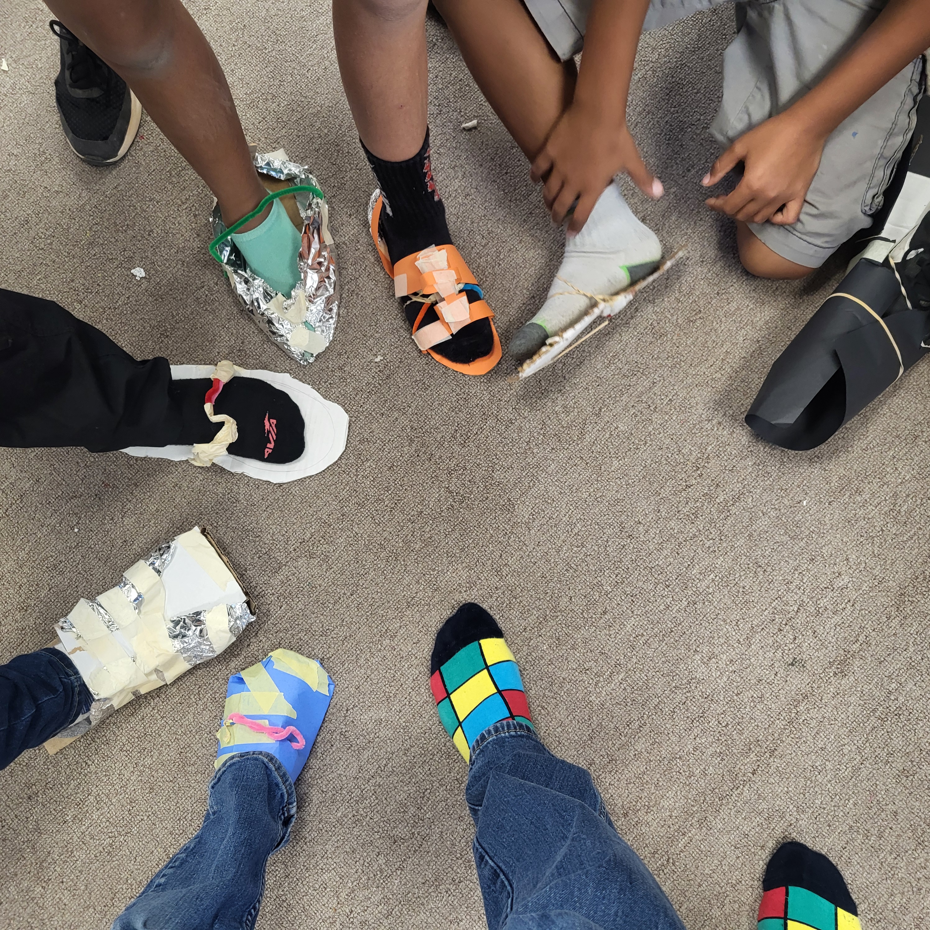 Picture of student made shoes made from crafting material as part of our Survivor unit.