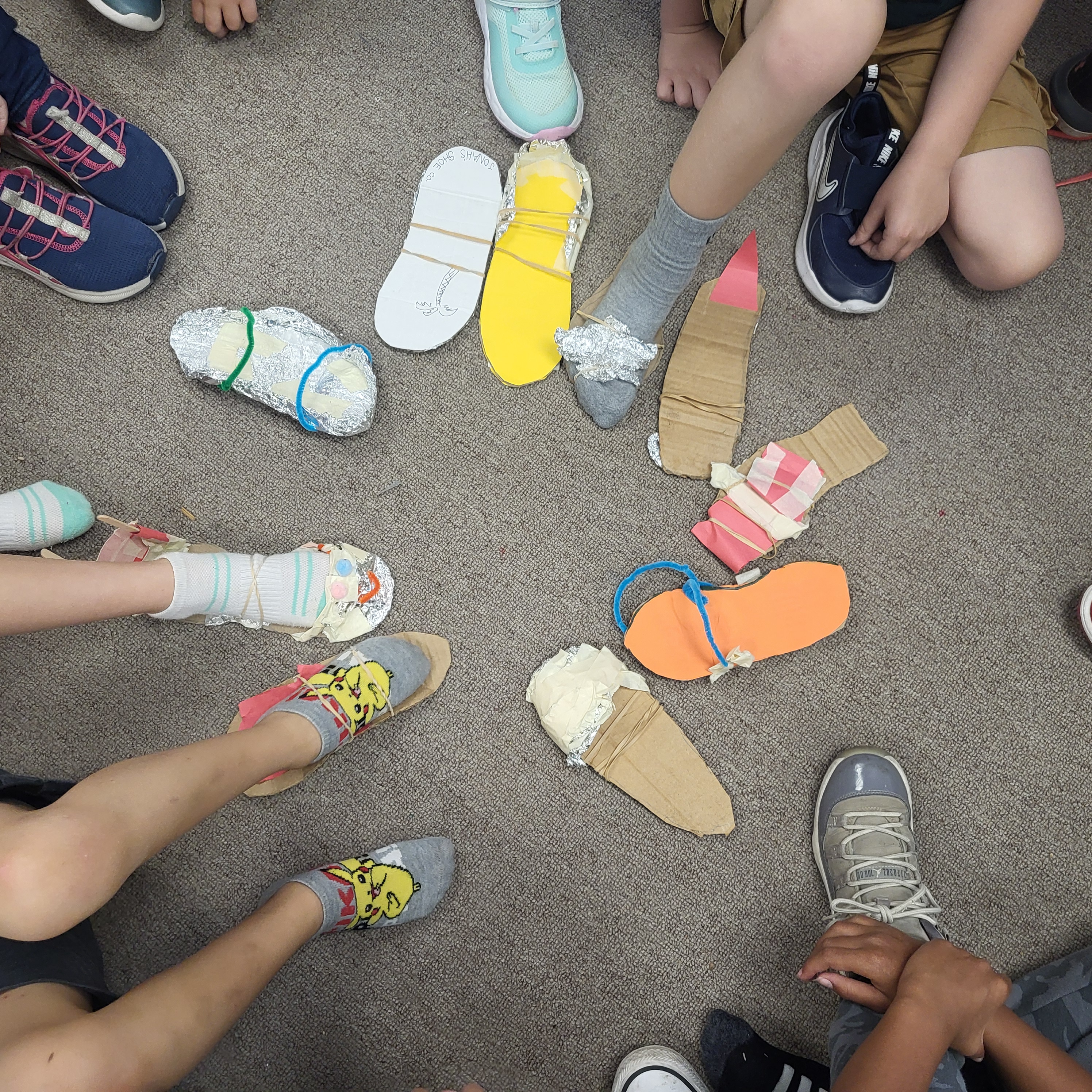 Picture of student made shoes made from crafting material as part of our Survivor unit.