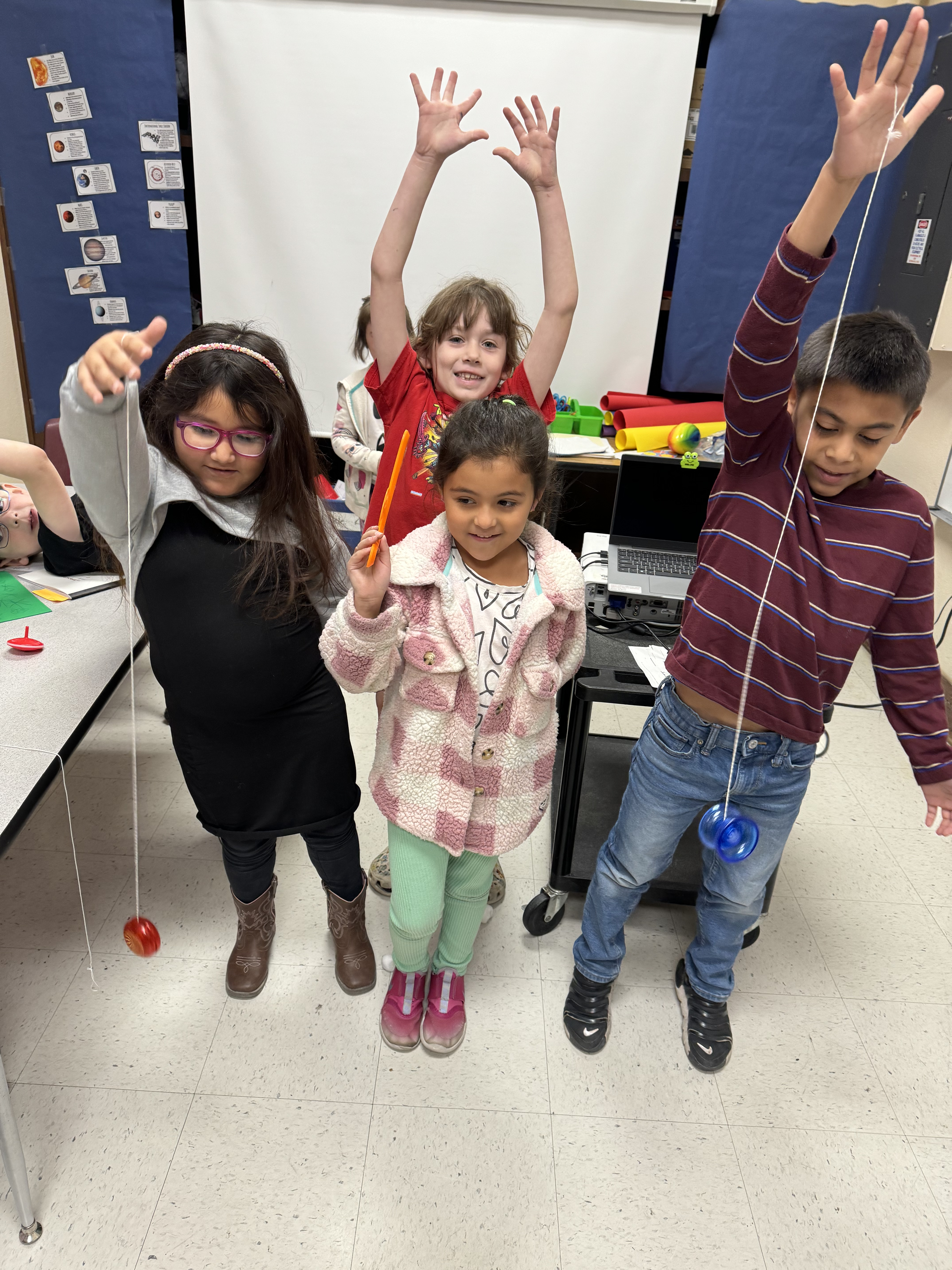 Students playing with toy yoyos.