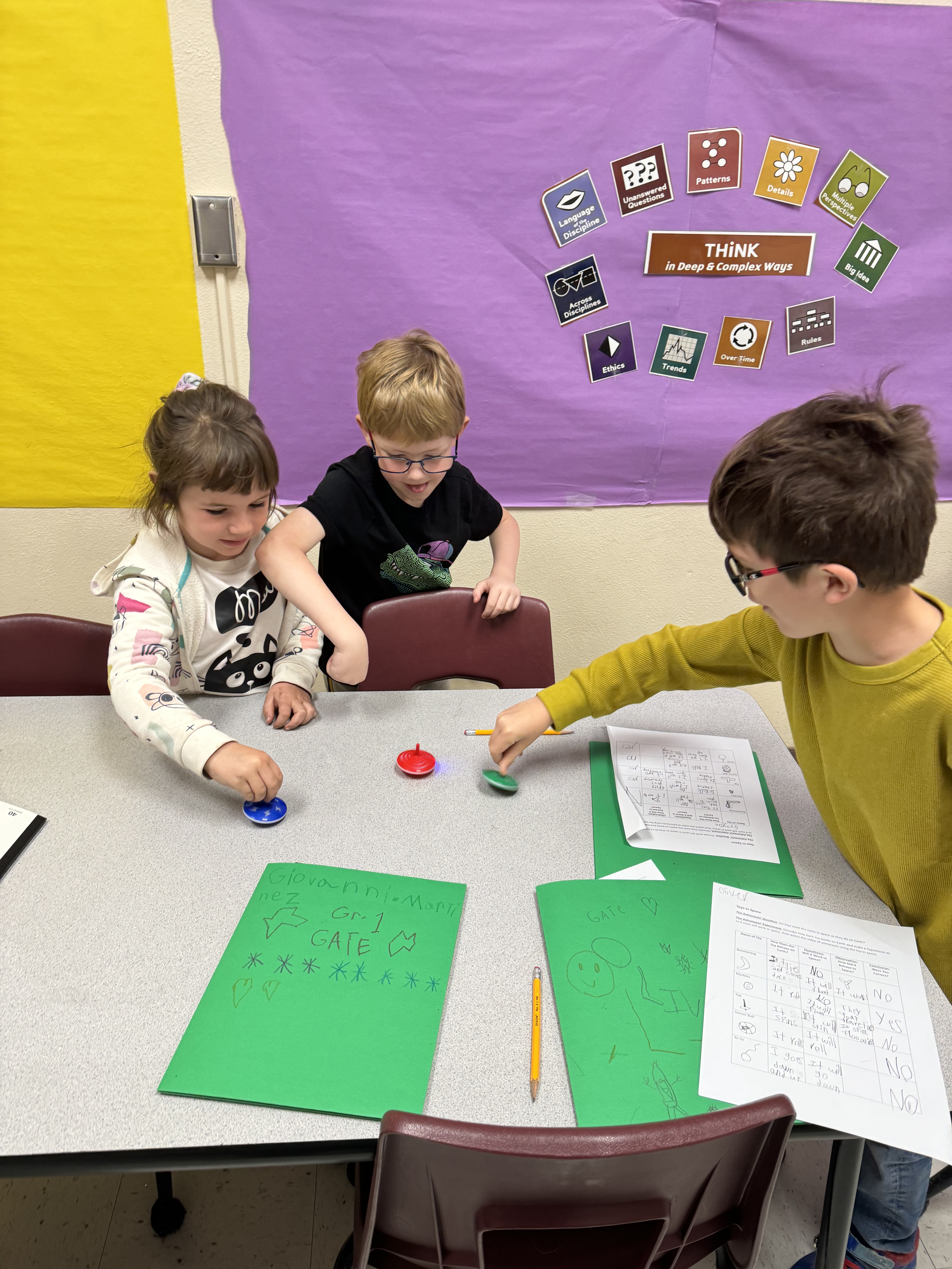 Students playing with toy tops.