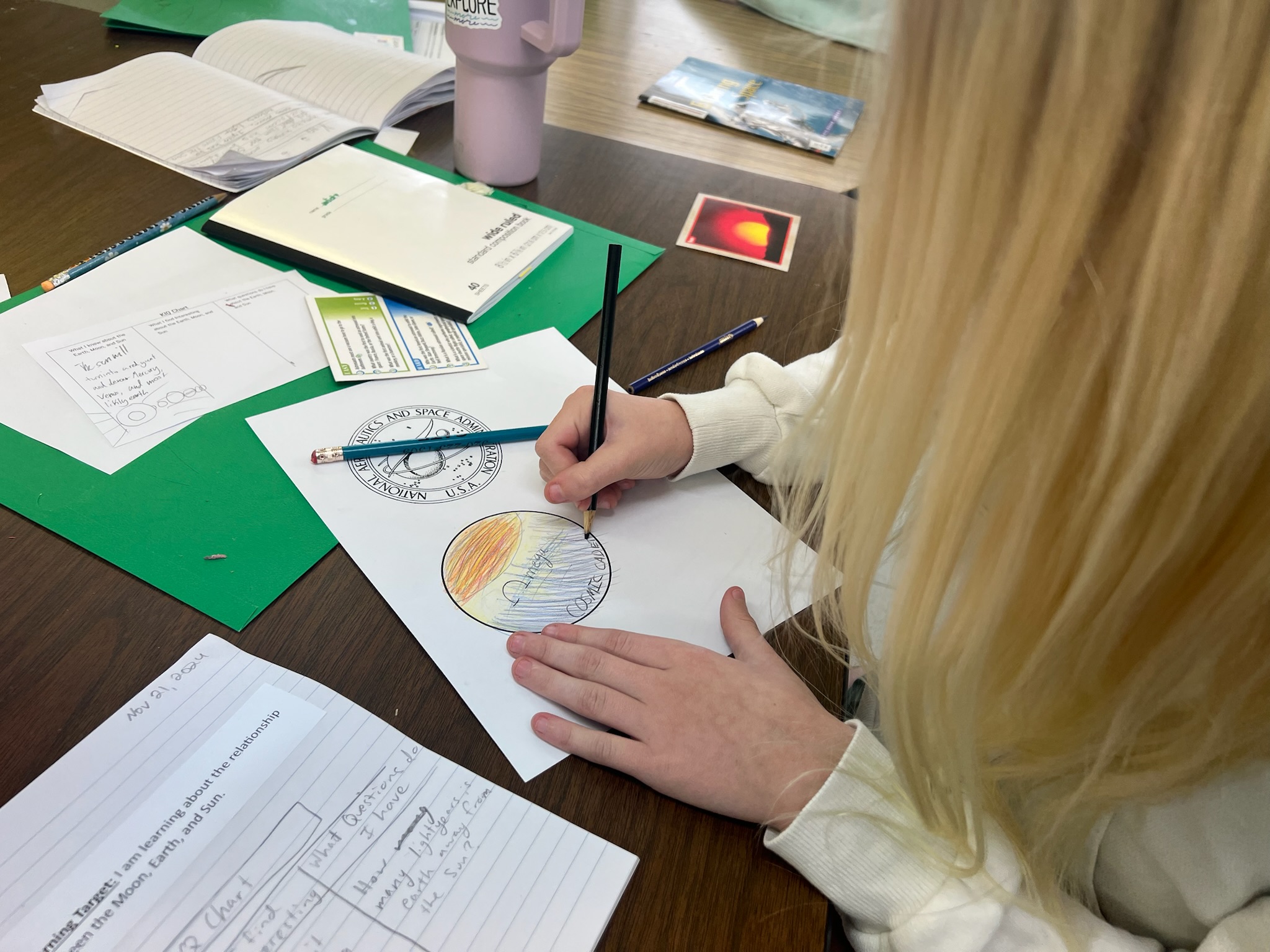 Student(s) engaged in displaying a creative NASA logo for Astronaut Academy unit