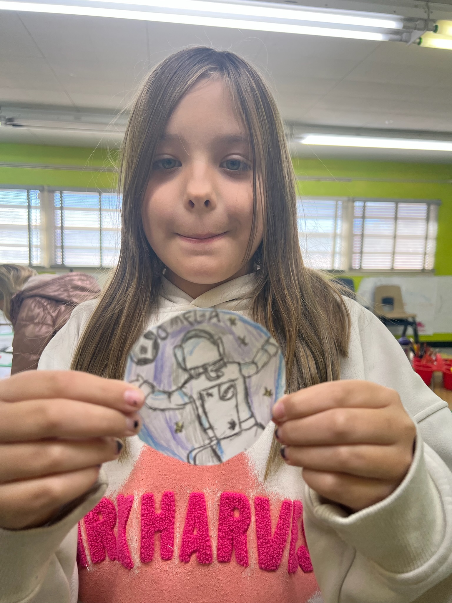 Student(s) engaged in displaying a creative NASA logo for Astronaut Academy unit