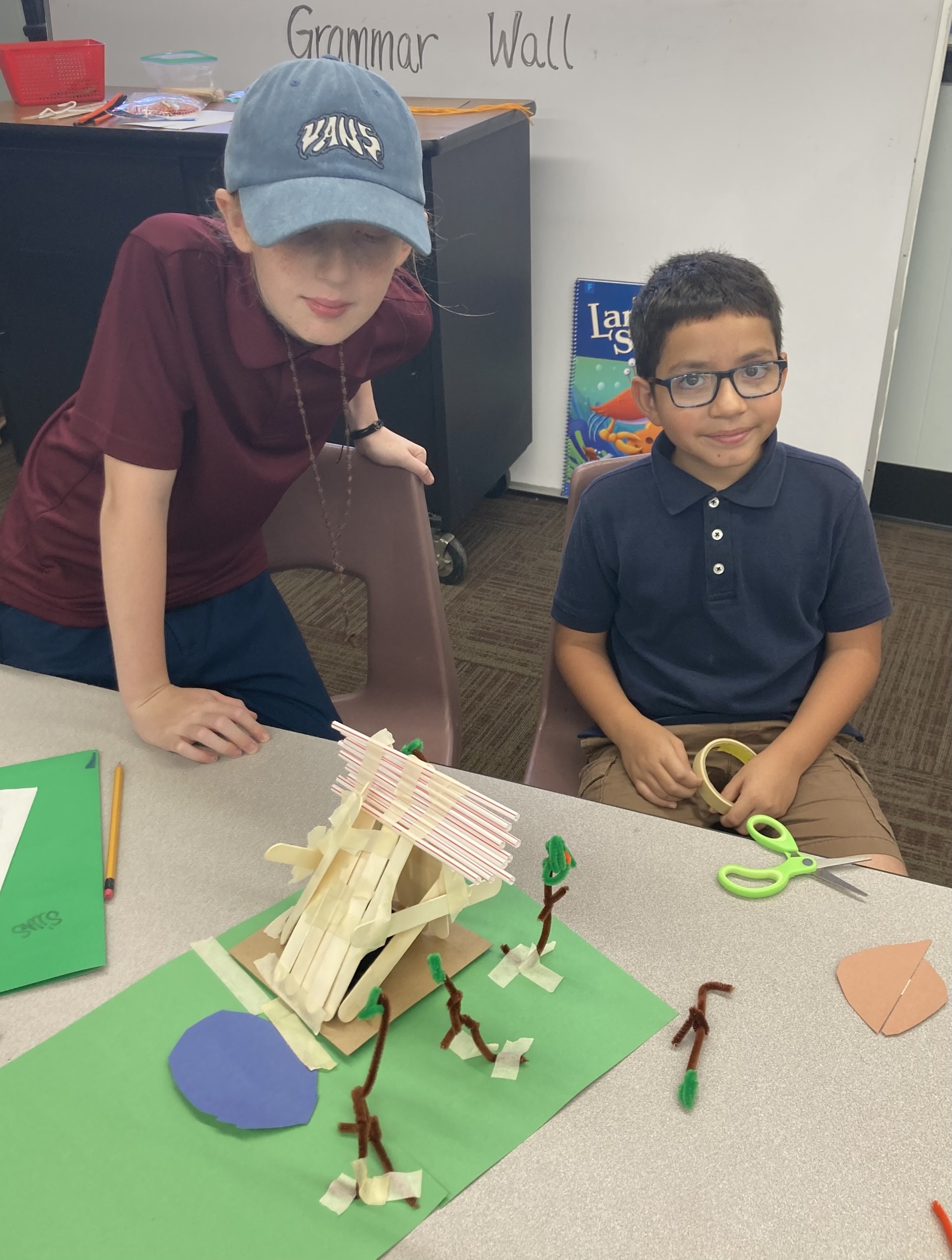 Picture features two of Mrs. Gallus's students making a shelter for the Survivor unit. 