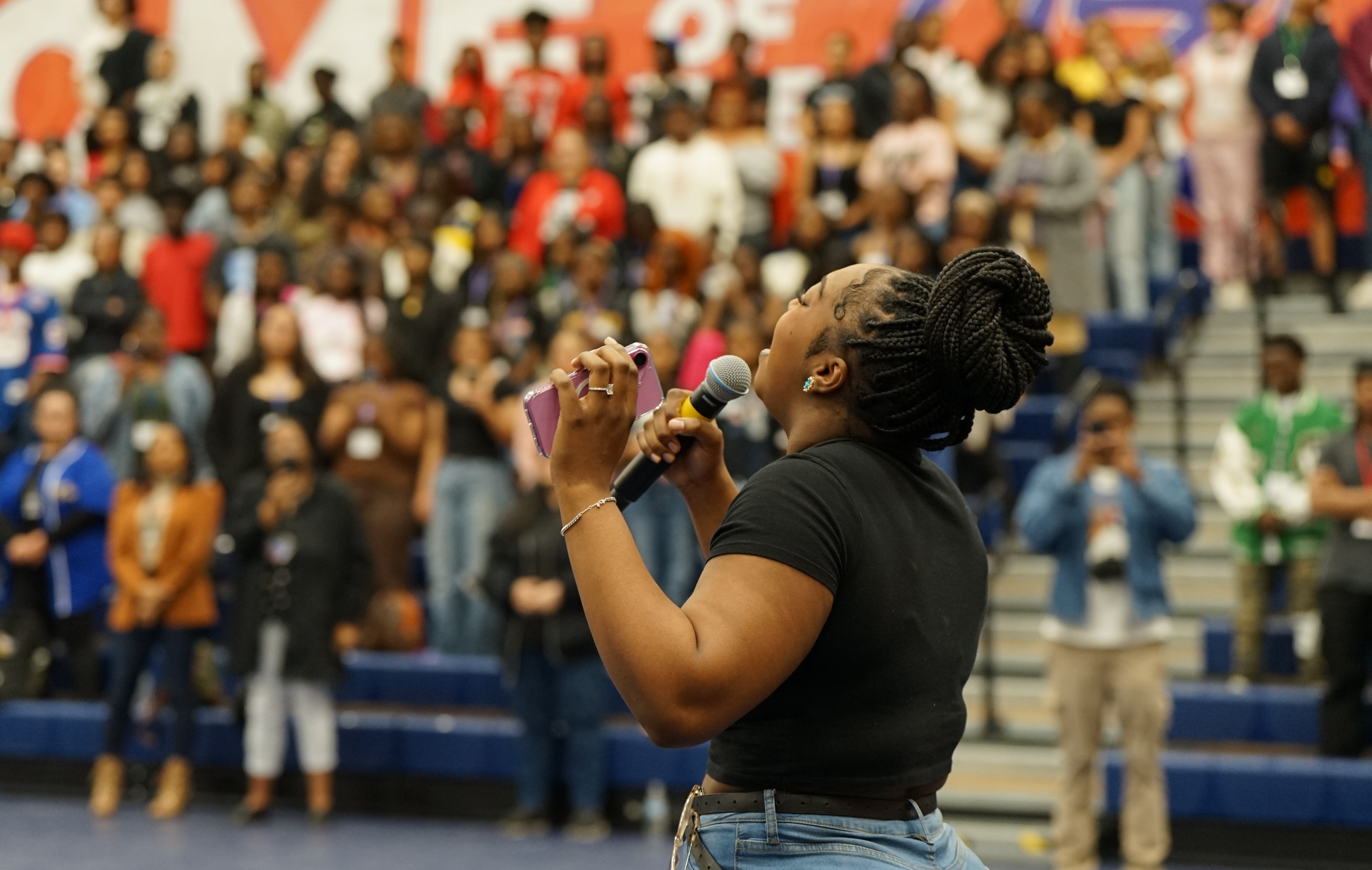 An African American woman talks to a crowd of students