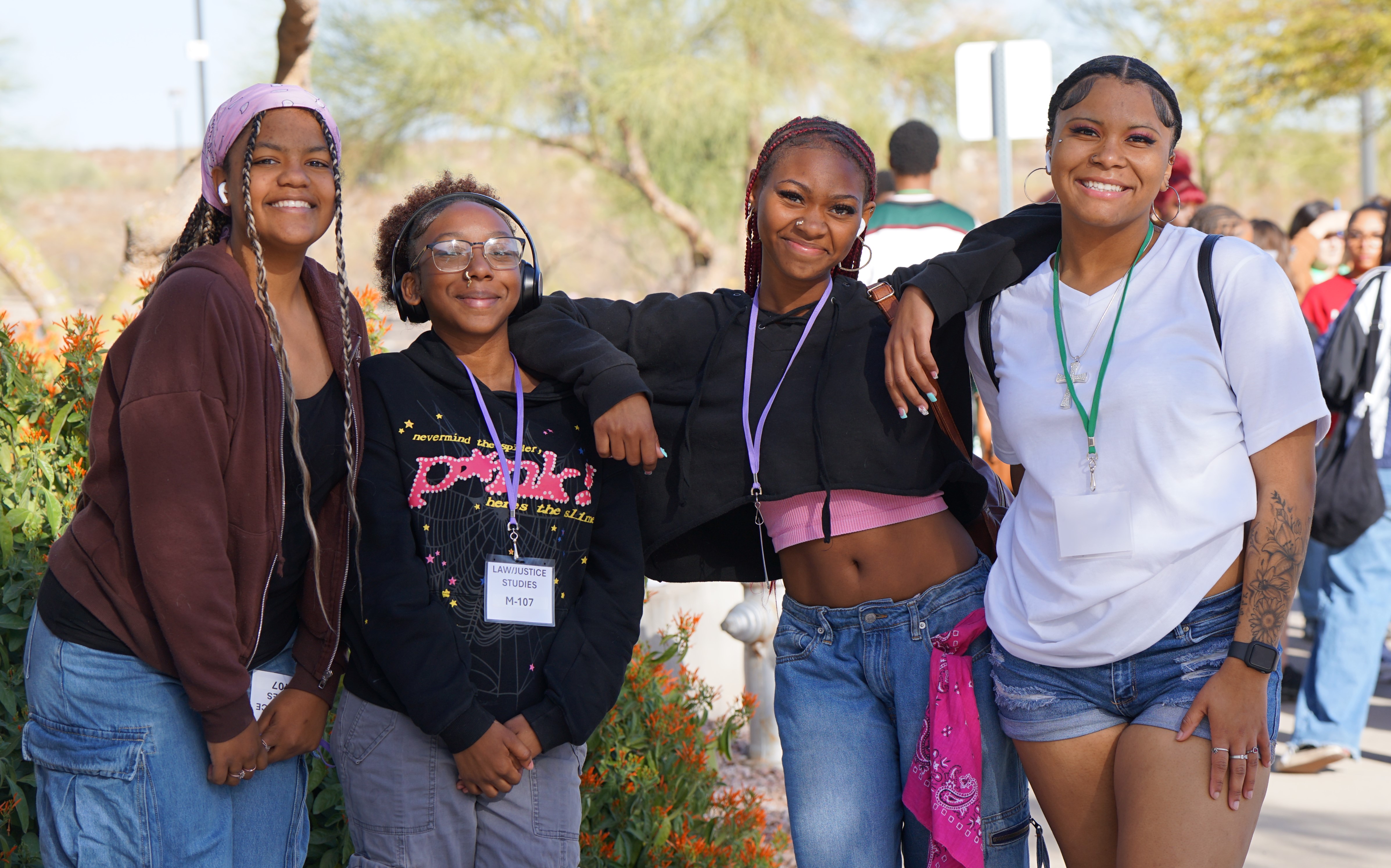 Four teen girls pose for a photo together outside