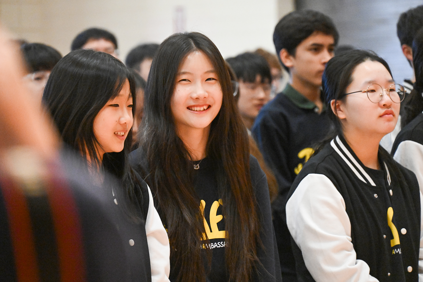 Korean students laugh together during the TKAP opening ceremony