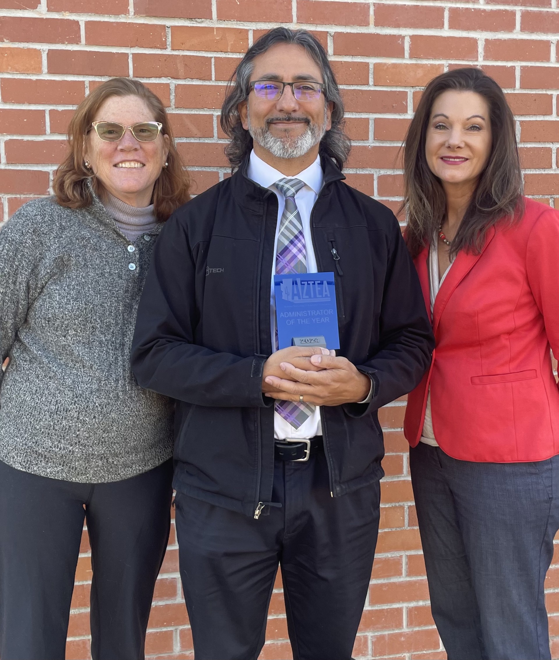 Daniel Sanchez poses with his award, with Halley Freitas on his left and Tracey Rowley on his right.