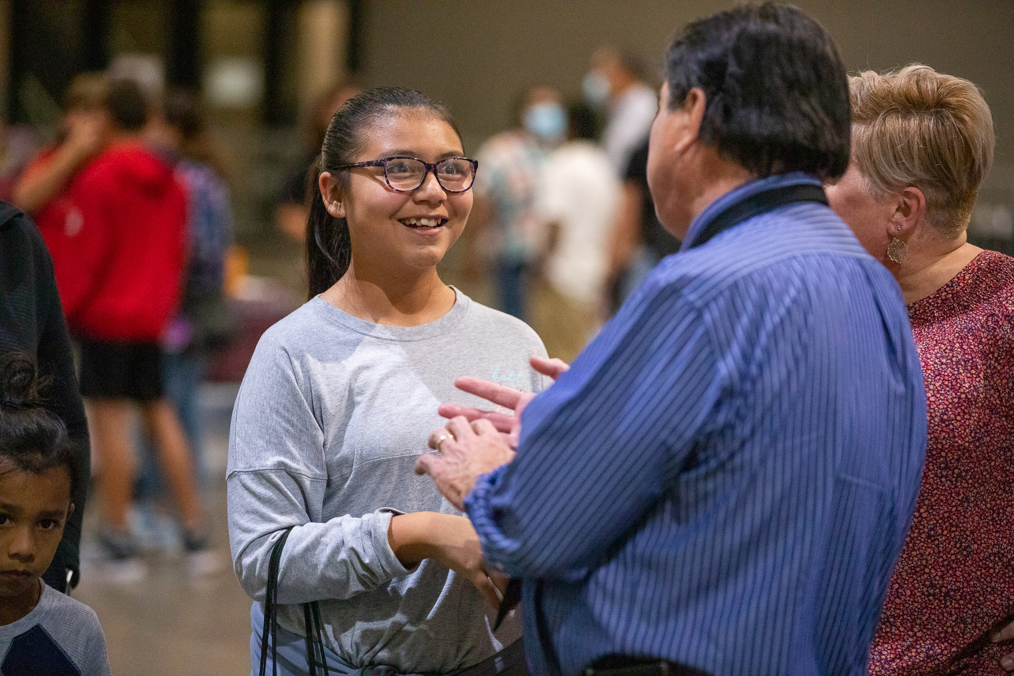 Administrator shaking hands with student