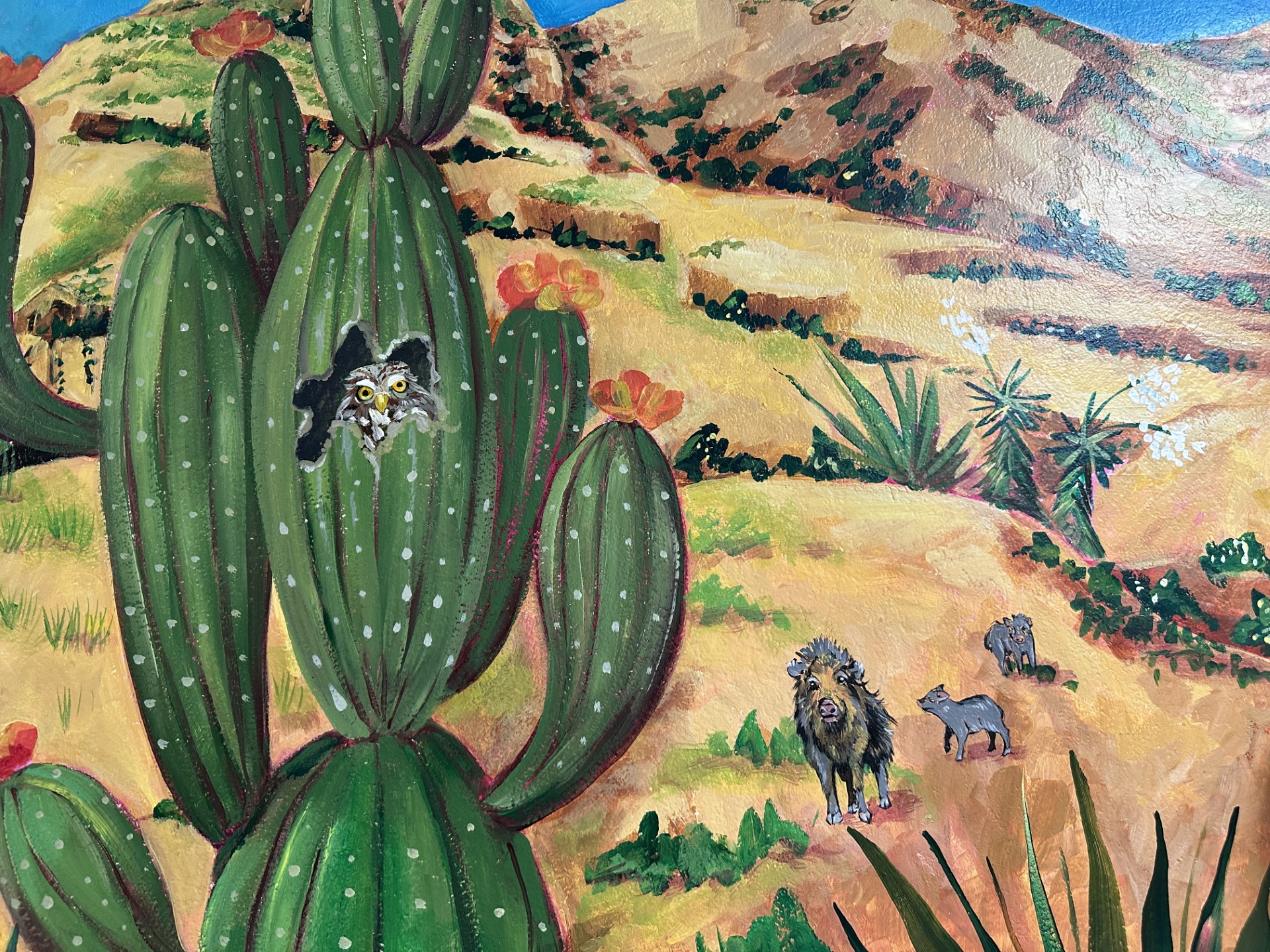 A closeup of the new mural, featuring an owl in a cactus and a javelina