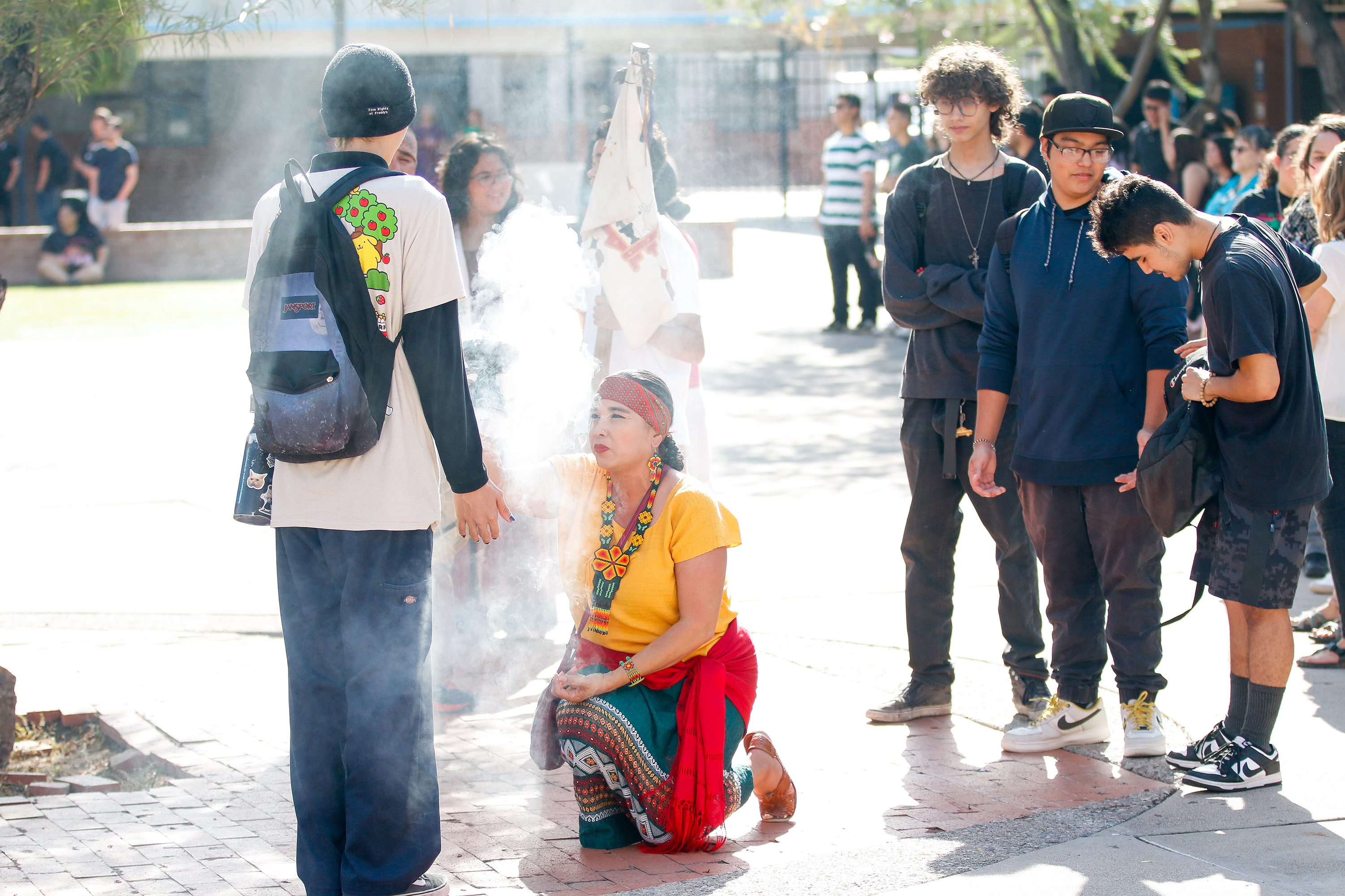 A woman performs the Calpolli Teoxicalli service with a student