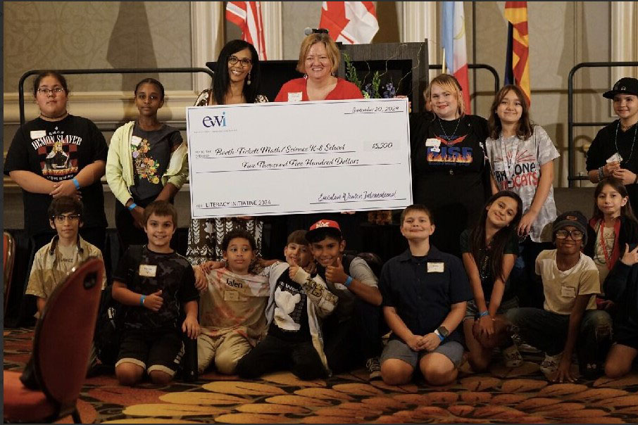 Booth-Fickett staff and students pose with their giant check from EWI