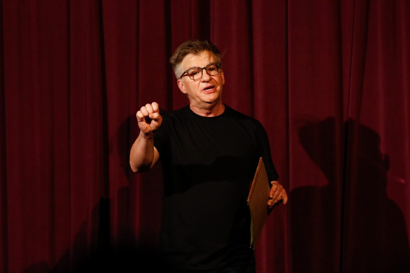 Tucson High drama teacher Art Almquist holds up his fist while directing students