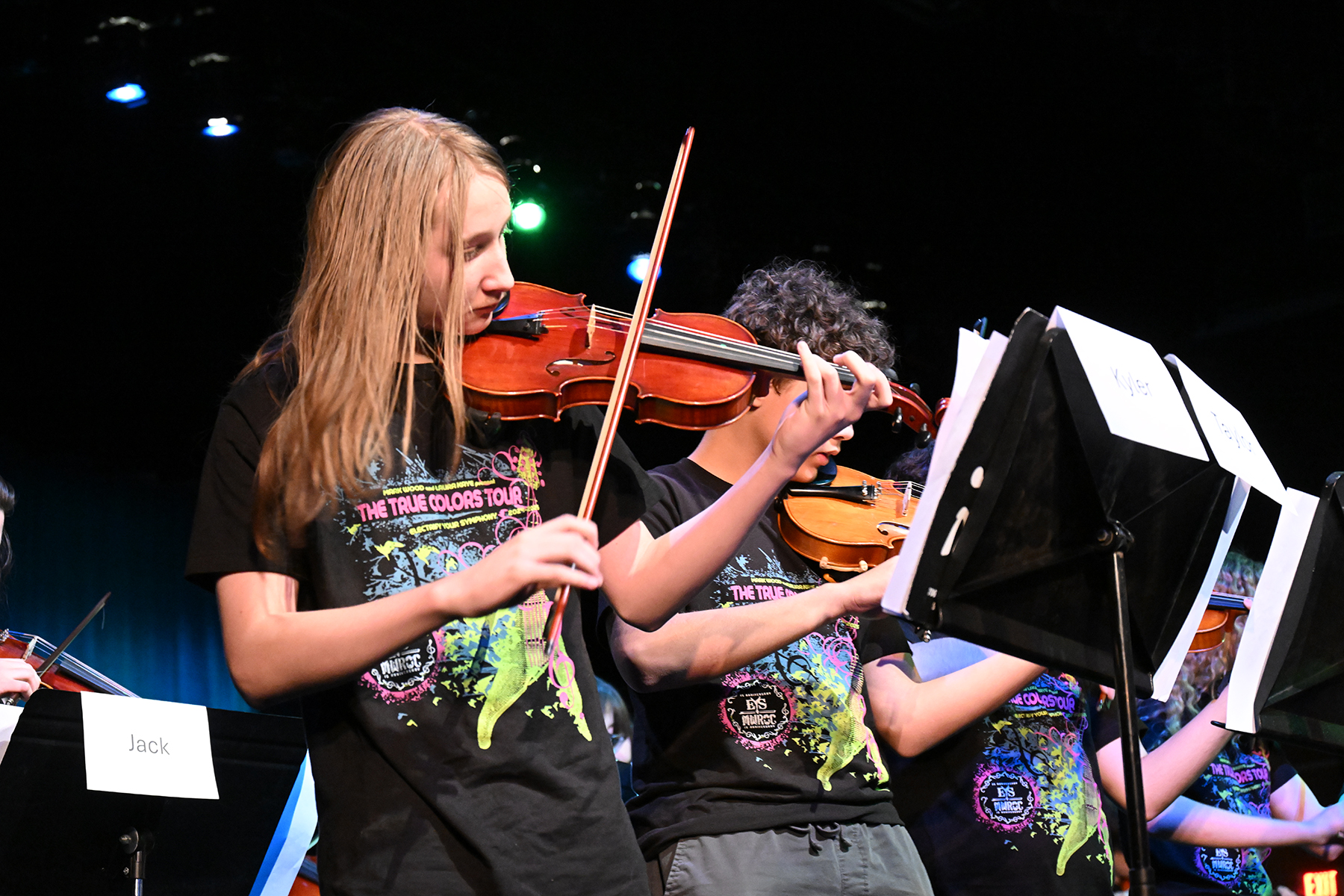 A girl intently plays her violin