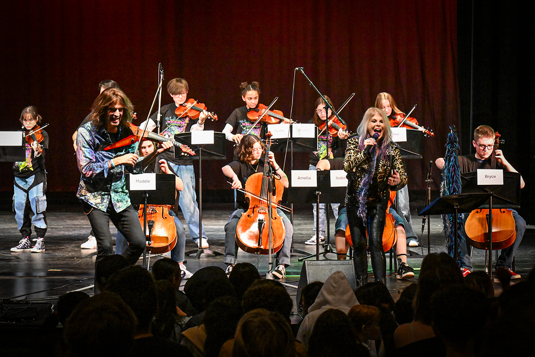 Students perform on stage with Mark Wood