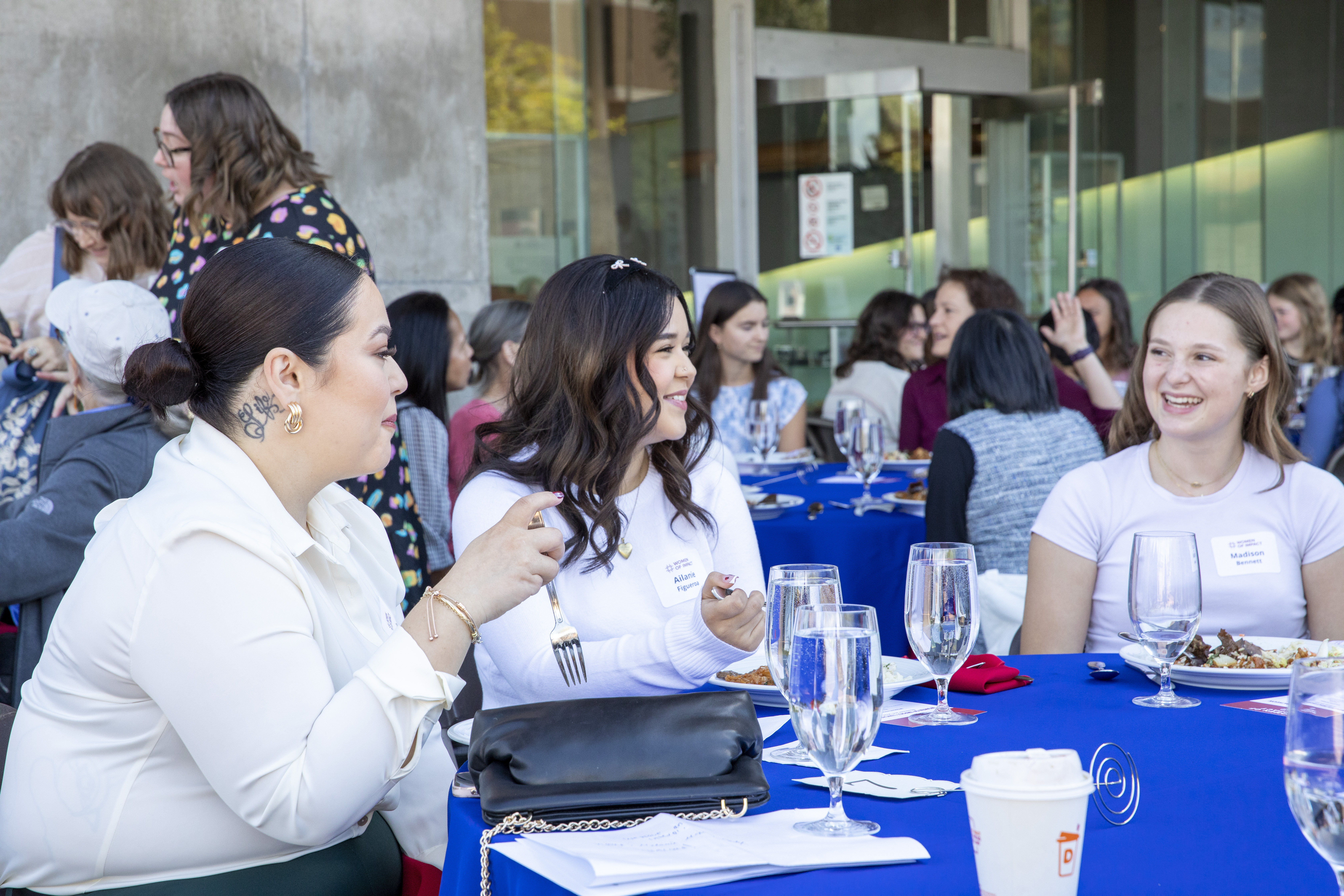 Teen girls chat happily at a luncheon table